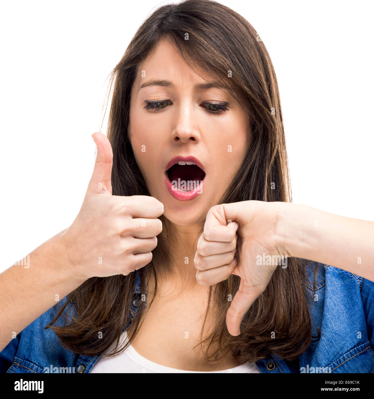 Beautiful woman confused making thumbs up and down Stock Photo