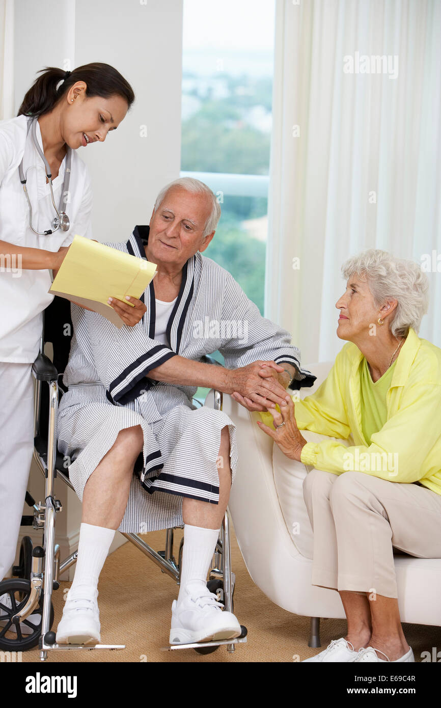 Nurse talking to Senior couple Stock Photo