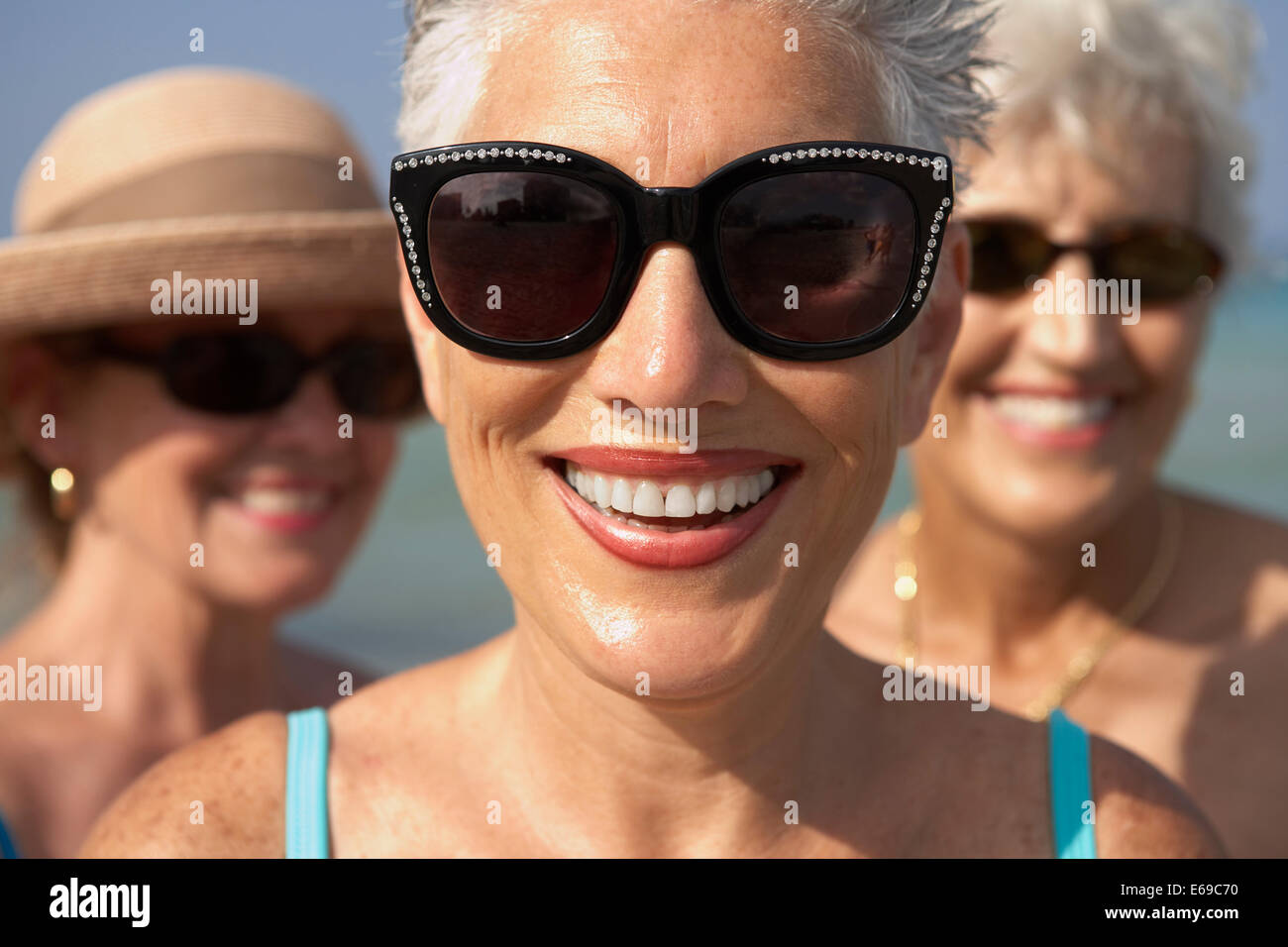 Senior woman wearing sunglasses on beach Stock Photo