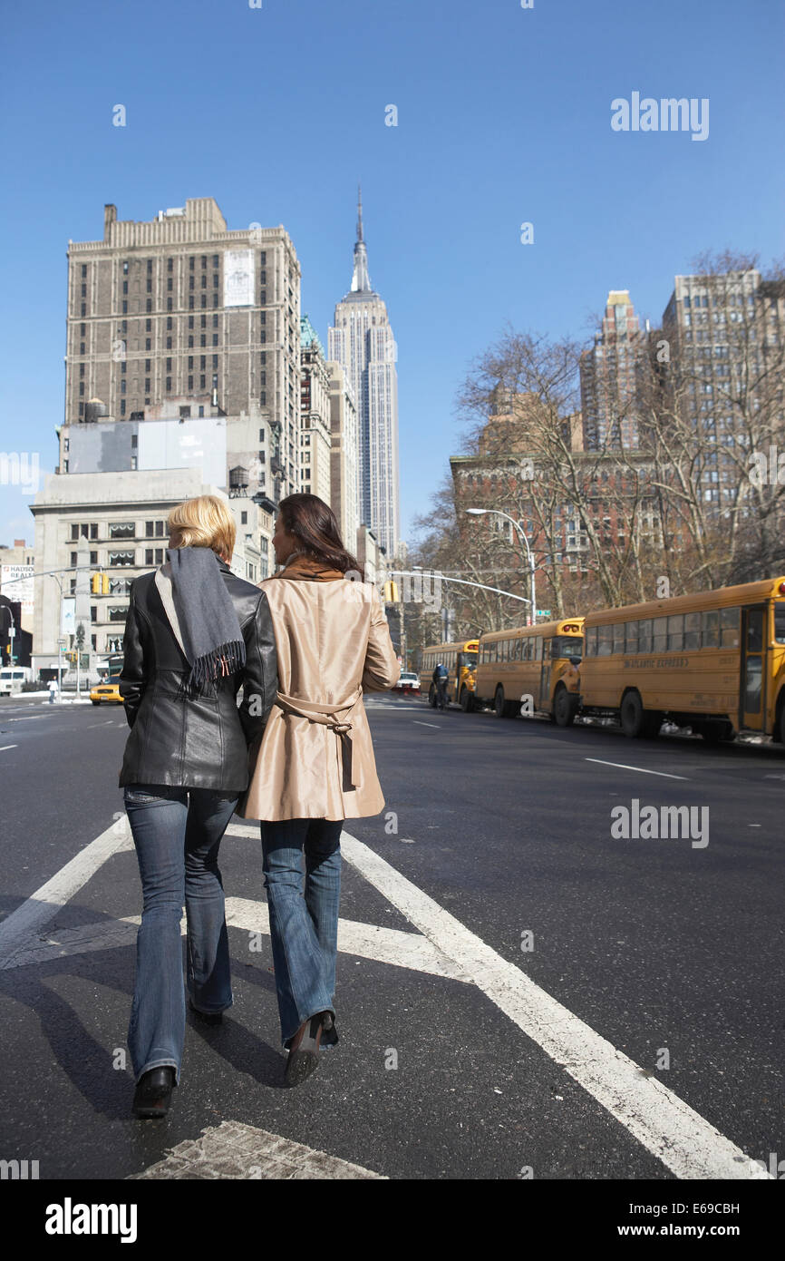 Women walking together on city street Stock Photo - Alamy