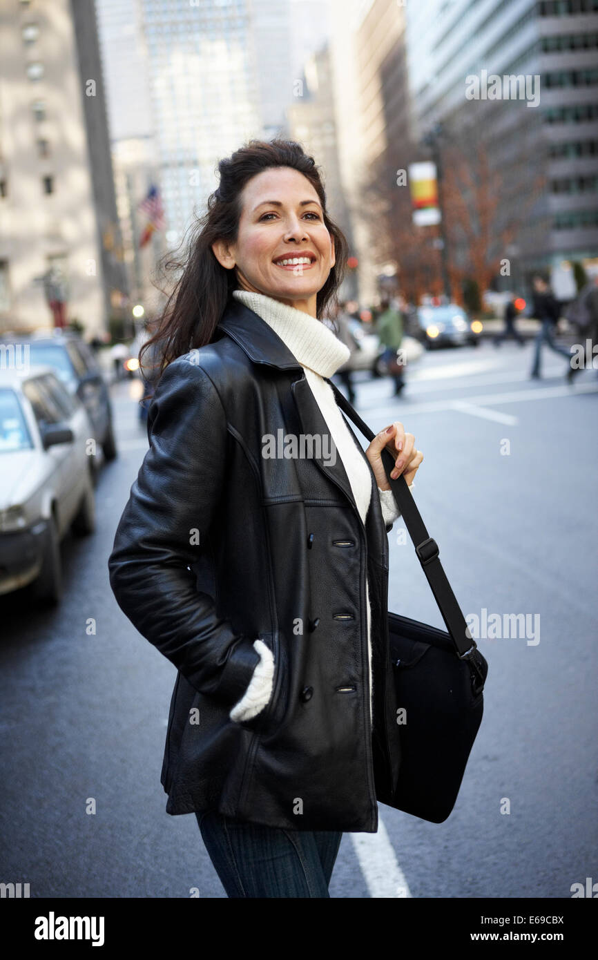 Woman smiling on city street Stock Photo - Alamy
