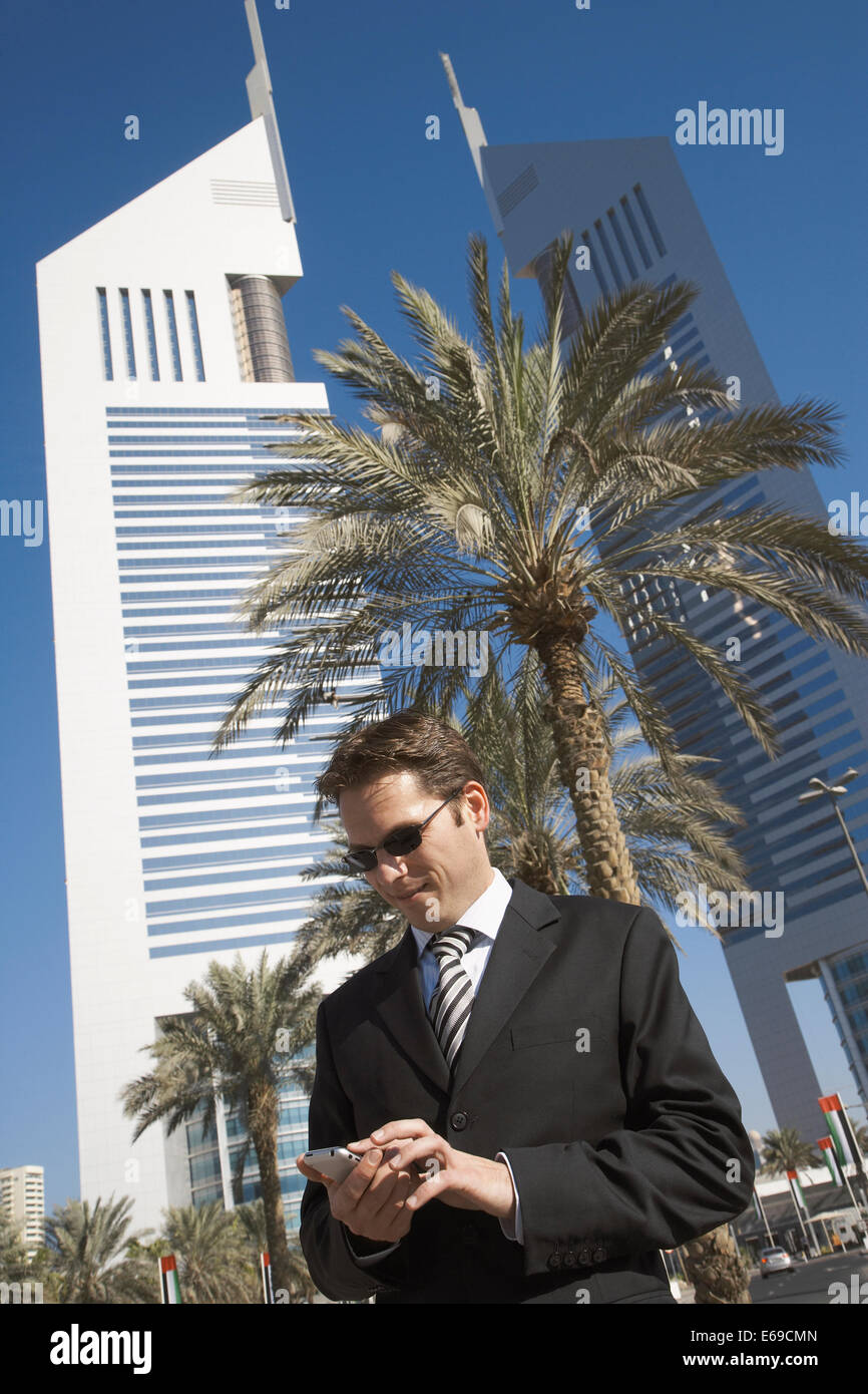Caucasian businessman using cell phone, Dubai, United Arab Emirates Stock Photo