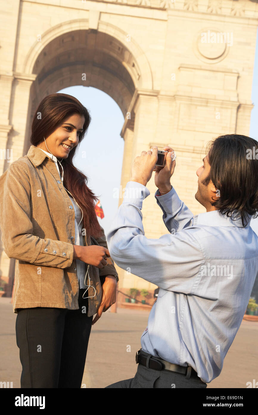 Indian couple taking pictures by monument, Delhi, India Stock Photo
