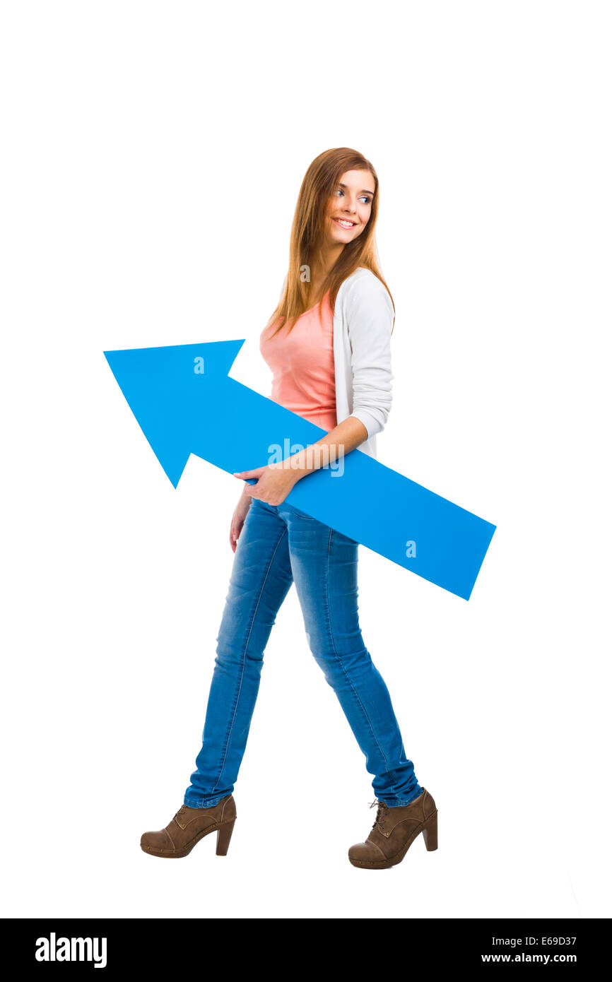 Beautiful woman walking while holding a blue arrow Stock Photo - Alamy