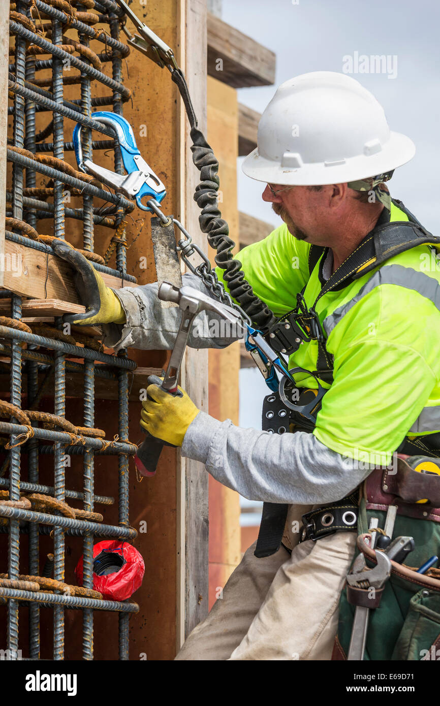 Caucasian worker examining wall at construction site Stock Photo