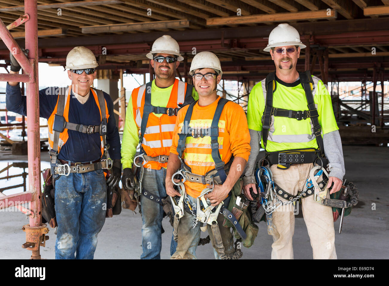 Workers smiling at construction site Stock Photo