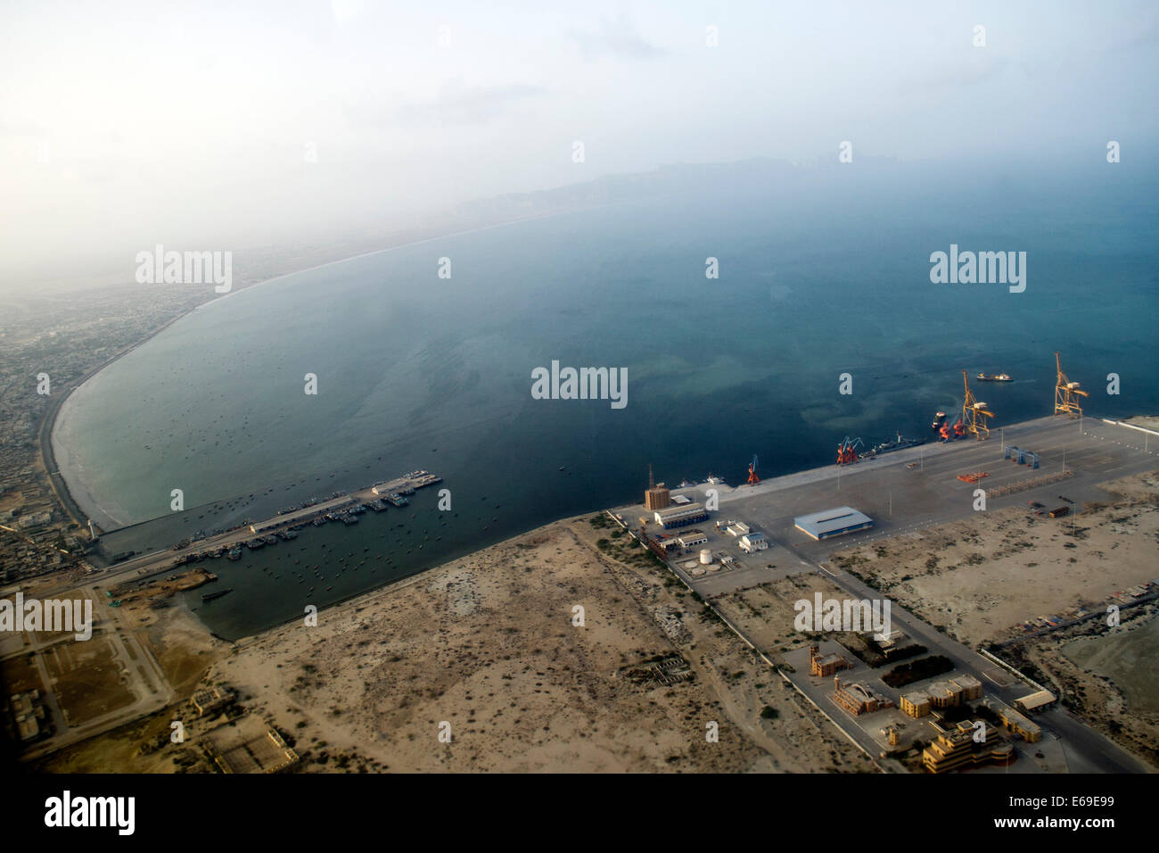 Islamabad. 18th Aug, 2014. Photo taken on Aug. 18, 2014 shows an aerial view of Gwadar Port in Balochistan province, Pakistan. Gwadar Port is a warm-water, deep-sea port situated on the Arabian Sea at Gwadar in Balochistan province of Pakistan. Gwadar Port is owned by the government-owned Gwadar Port Authority and operated by China Overseas Port Holding Company (COPHC). © Huang Zongzhi/Xinhua/Alamy Live News Stock Photo