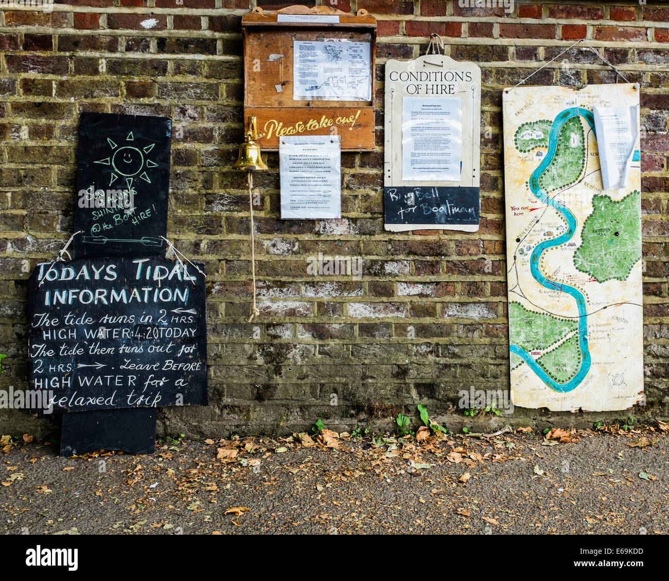 Thames Riverside Notice boards about boat hire, map and Tide information sign - Richmond upon Thames, Surrey, London, UK Stock Photo