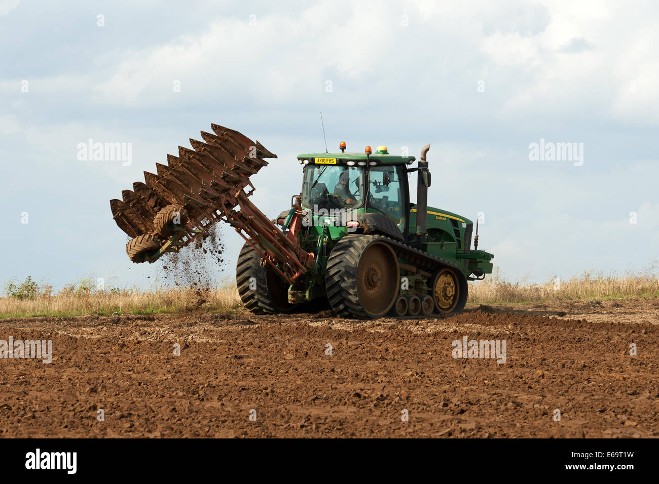 Tractor at the end of a field turing over plough Stock Photo