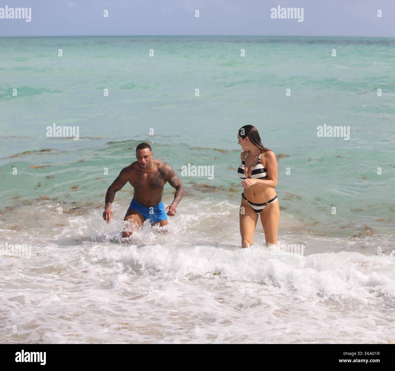 Kelly Brook and boyfriend David McIntosh relax together during their holiday in Miami where they  froliced in the surf before renting out bicycles and rode along South Beach to an outdoor gym.  Featuring: Kelly Brook,David McIntosh Where: Miami, Florida, United States When: 03 Feb 2014 Stock Photo