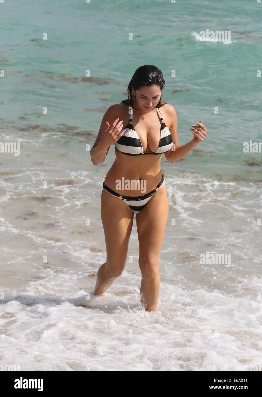 Kelly Brook and boyfriend David McIntosh relax together during their holiday in Miami where they  froliced in the surf before renting out bicycles and rode along South Beach to an outdoor gym.  Featuring: Kelly Brook Where: Miami, Florida, United States When: 03 Feb 2014 Stock Photo