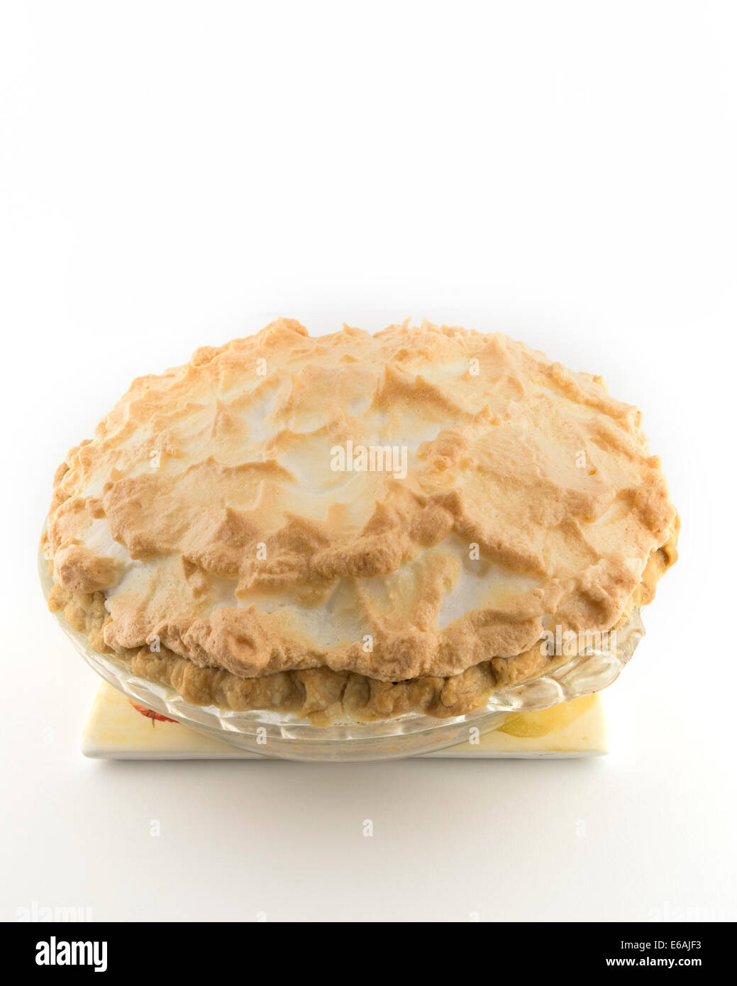 A whole freshly baked homemade chocolate cream meringue pie, cutout, white background. USA Stock Photo