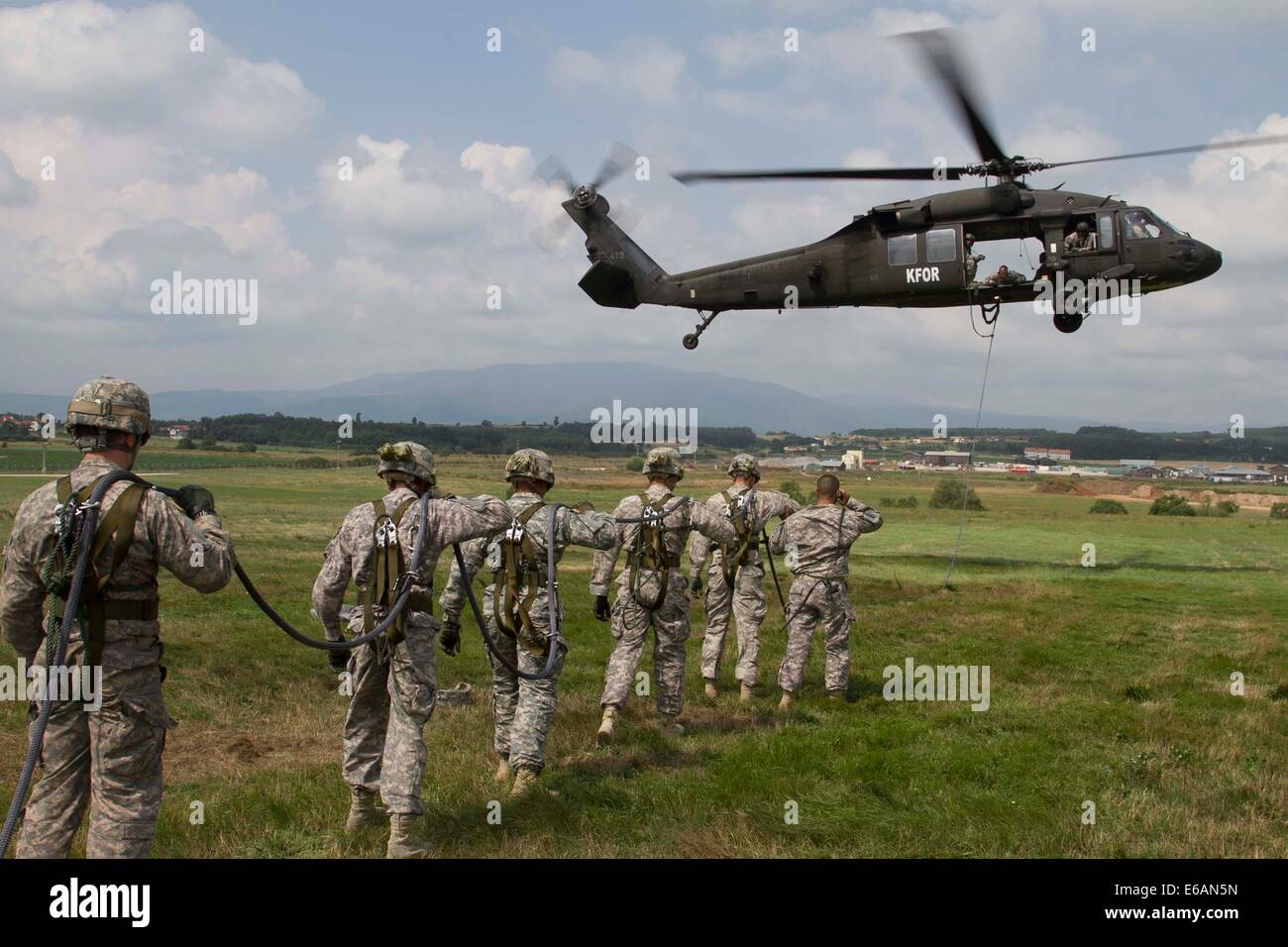 U.S. Soldiers with the 2nd Squadron, 38th Cavalry Regiment, 504th Battlefield Surveillance Brigade prepare to be hoisted on a fast-rope line July 18, 2014, during special-purpose insertion and extraction and fast-rope training at Camp Bondsteel, Kosovo Stock Photo