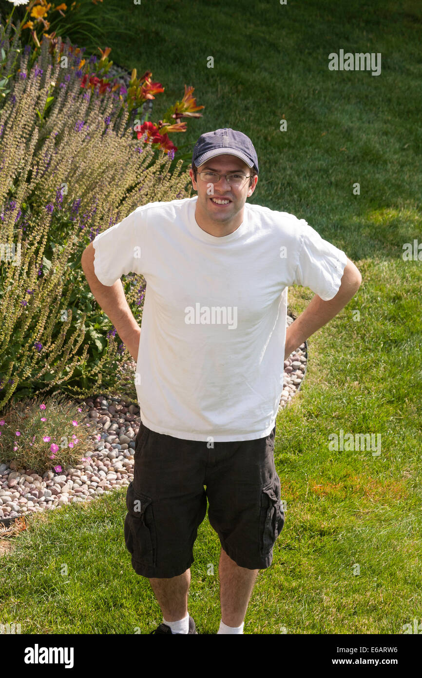 Happy Young Man, Casually Dressed, Residential Backyard, USA Stock Photo