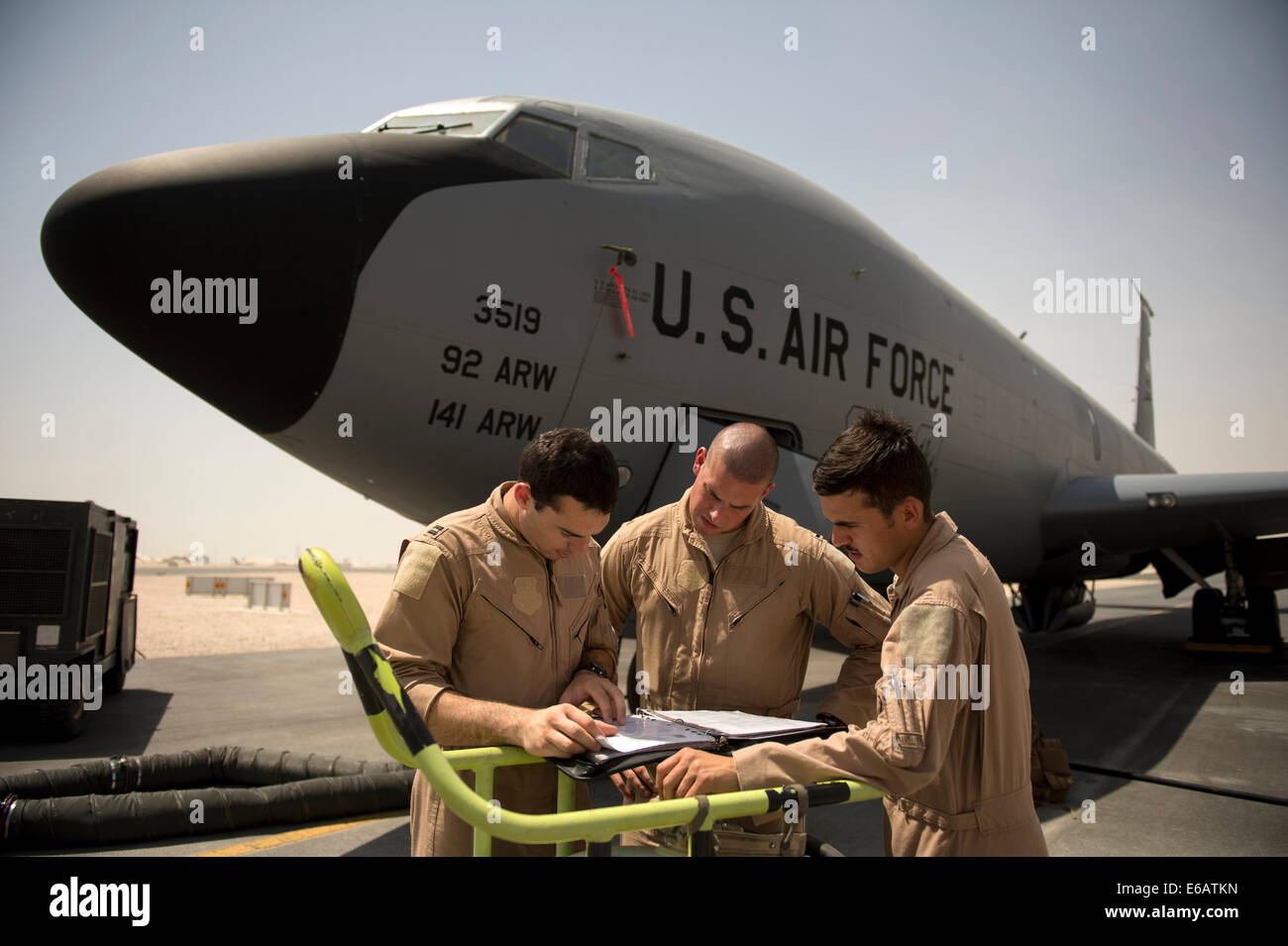 U.S. Air Force Capt. Christopher Carr, 1st Lt. Daniel Winningham and Airman 1st Class Jordan Gese, KC-135 Stratotanker aircrew members with the 340th Expeditionary Air Refueling Squadron, review a preflight inspection at an undisclosed location July 22, 2 Stock Photo