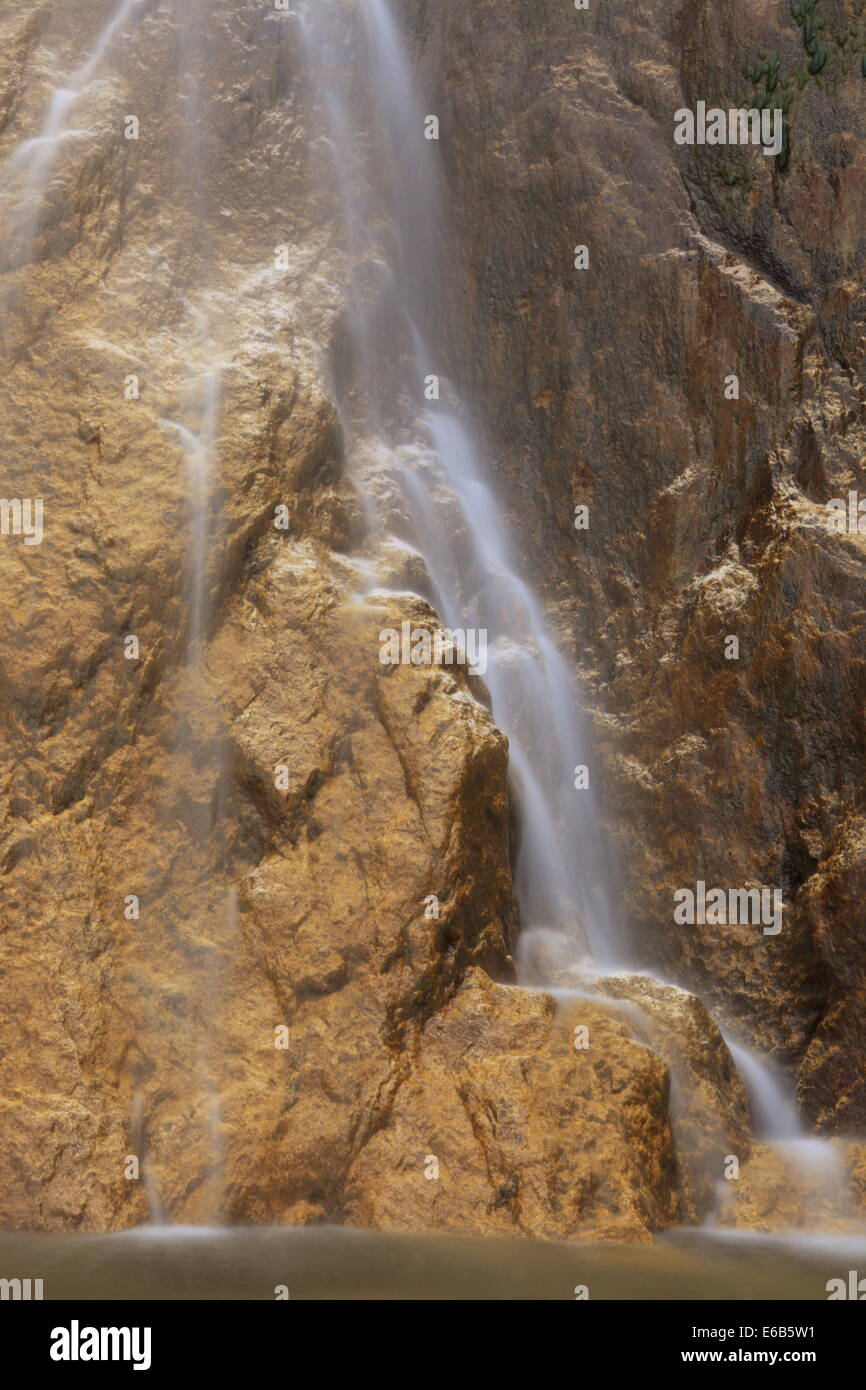 Waterfall in golden rocks aspect. Stock Photo