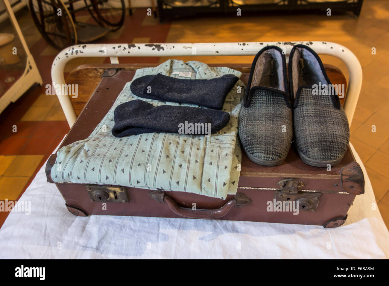 Suitcase with pyjamas and slippers of psychiatric patient on hospital bed, Dr Guislain Museum about psychiatry in Ghent, Belgium Stock Photo