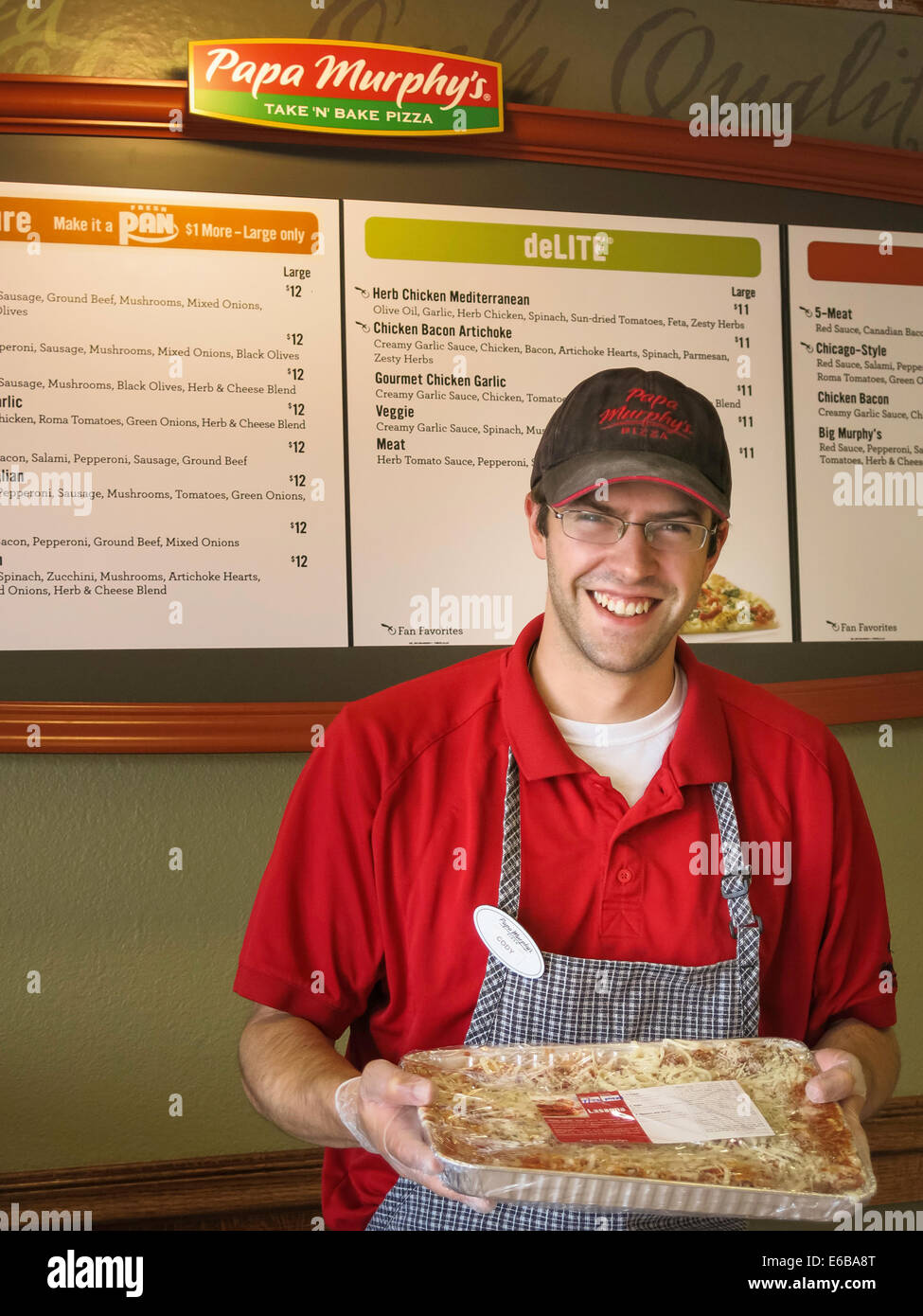 Small Business Owner of Pizza Shop with Tray of Lasagna, USA Stock