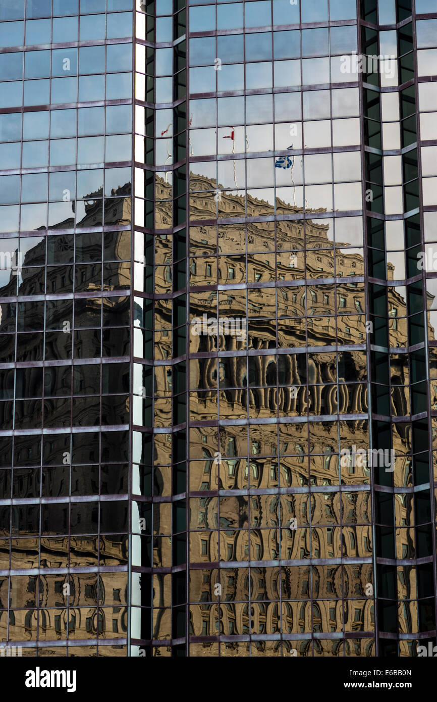 Reflection of an old building in a modern glass sky scraper in Montreal, Canada Stock Photo