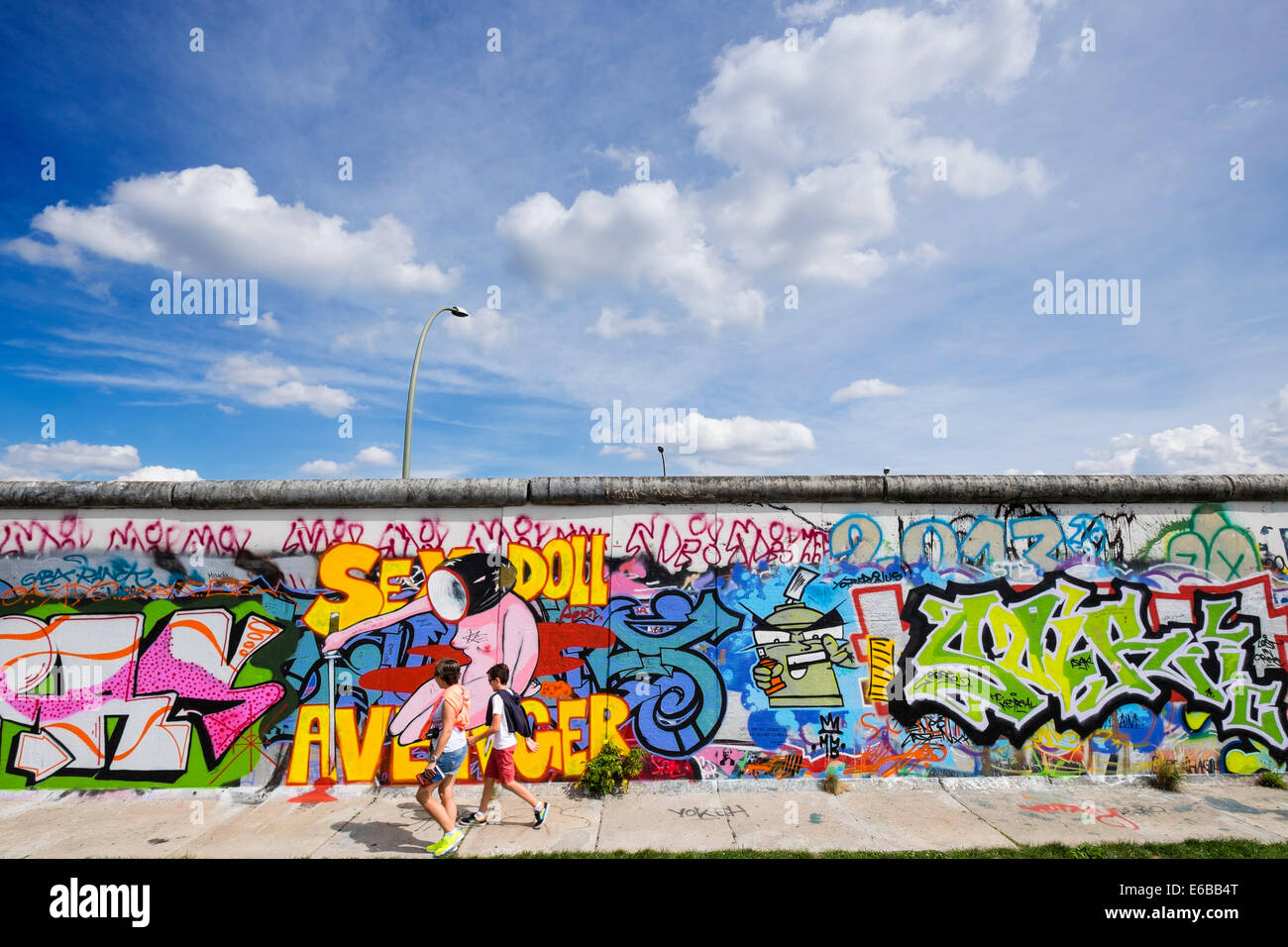 Berlin wall view; Graffiti on original section of Berlin Wall at East Side Gallery in Friedrichshain in Berlin Germany Stock Photo