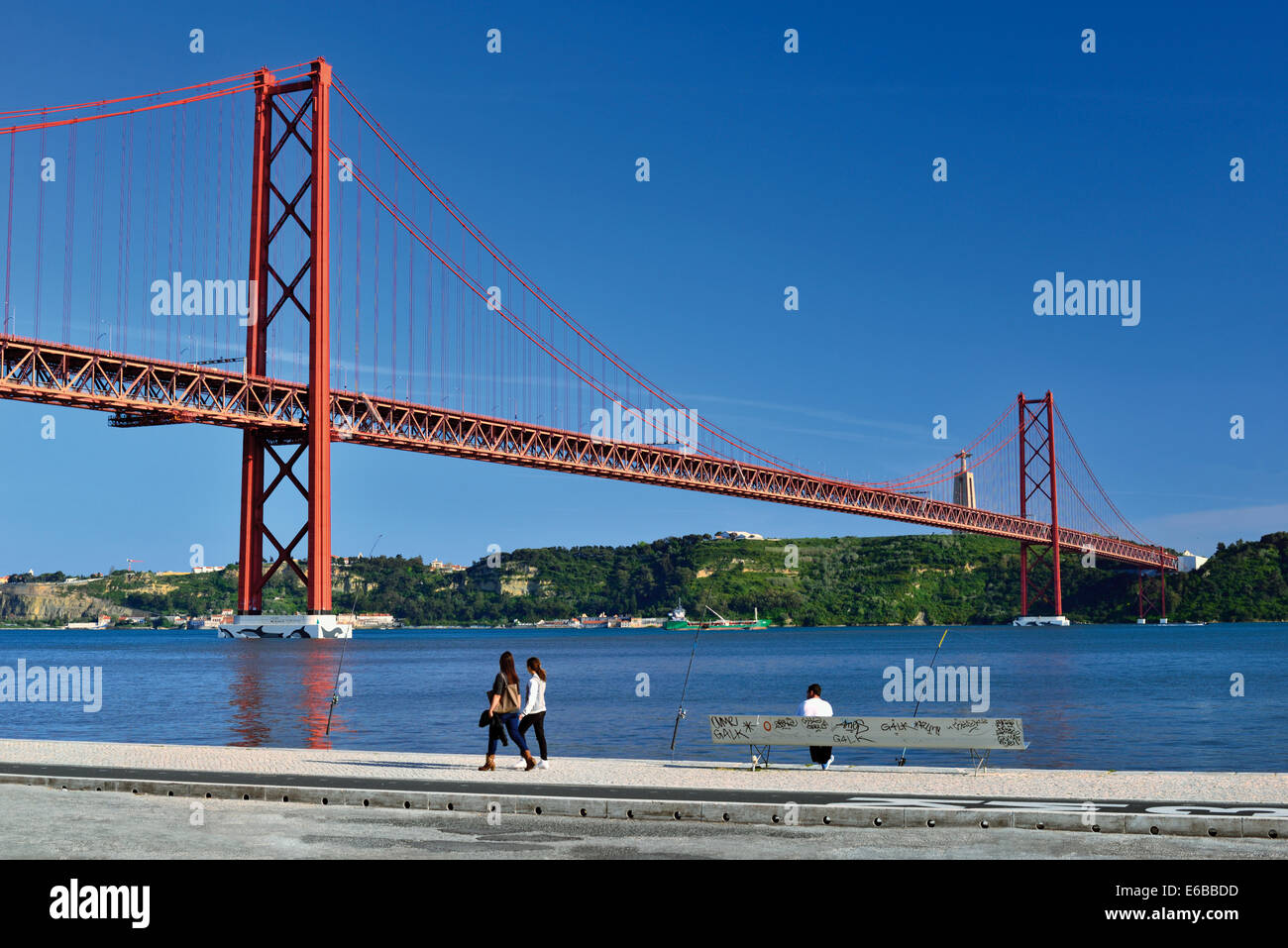 Portugal, Lisbon: People passing near riverside at bridge Ponte 25 de Abril Stock Photo