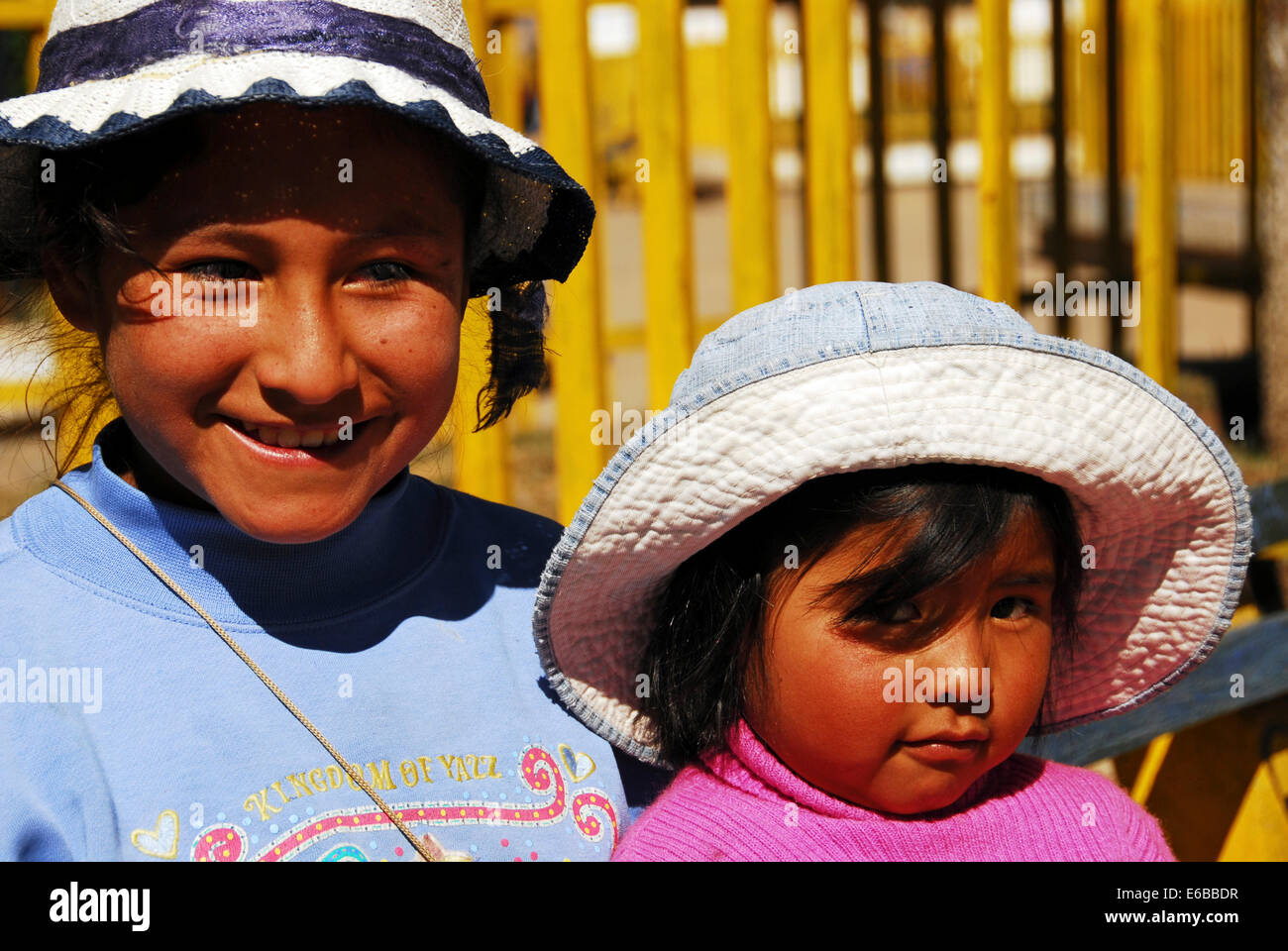 Bolivia, El alto, portrait of two cute smiling girls wearing hats. Stock Photo