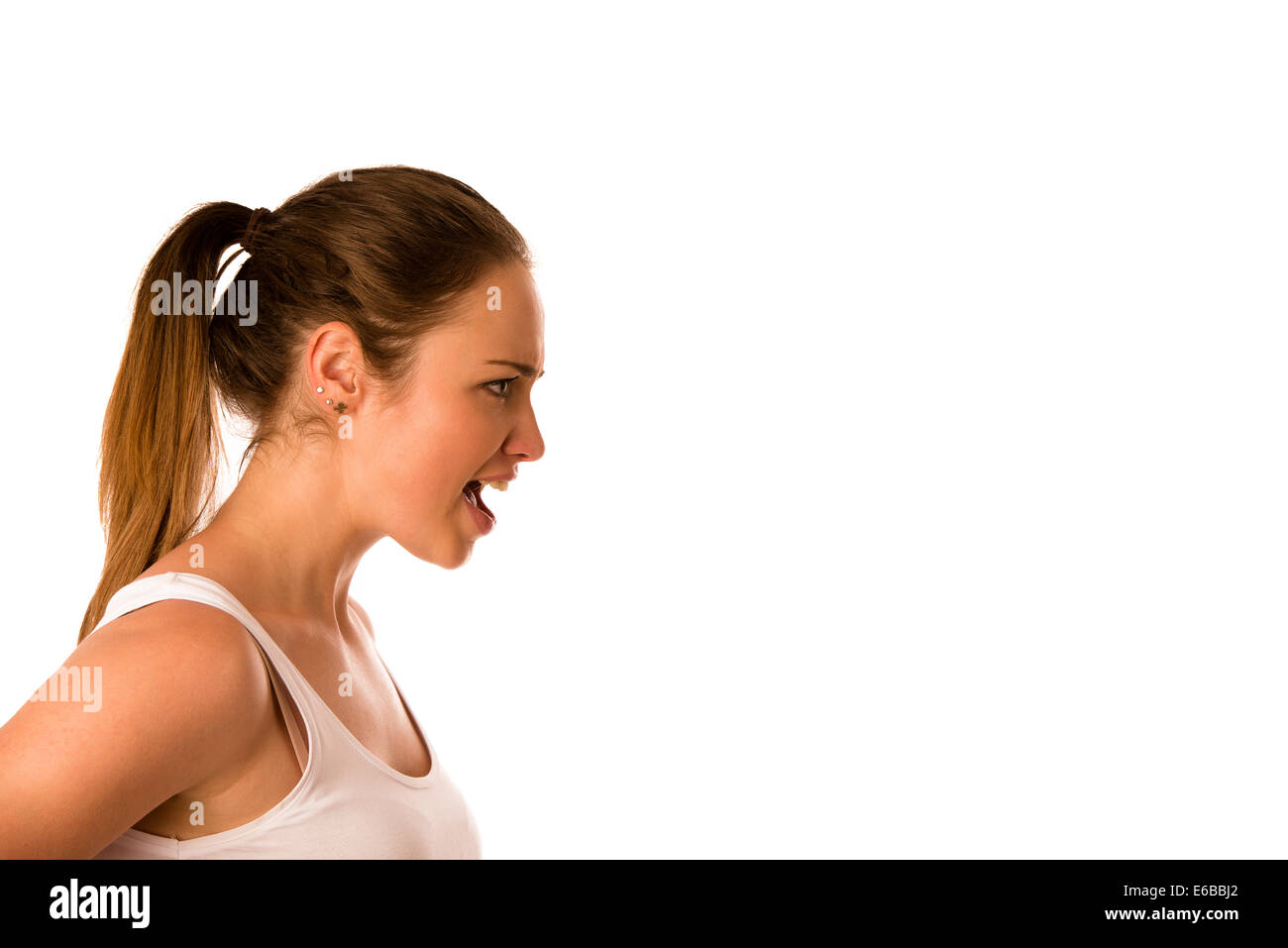 Angry young woman screams into a copy space isolated Stock Photo