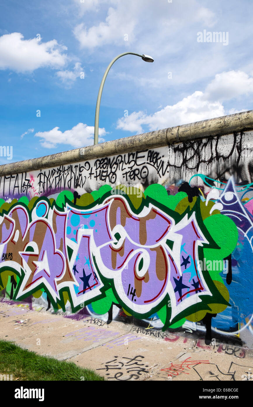 Graffiti on original section of Berlin Wall at East Side Gallery in Friedrichshain in Berlin Germany Stock Photo
