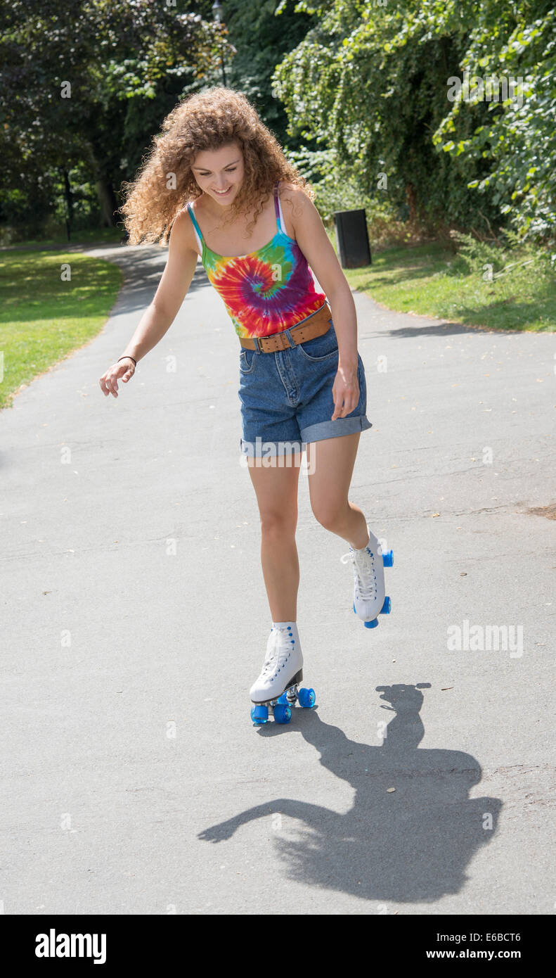 Teenager on roller skates not looking too confident skating along a