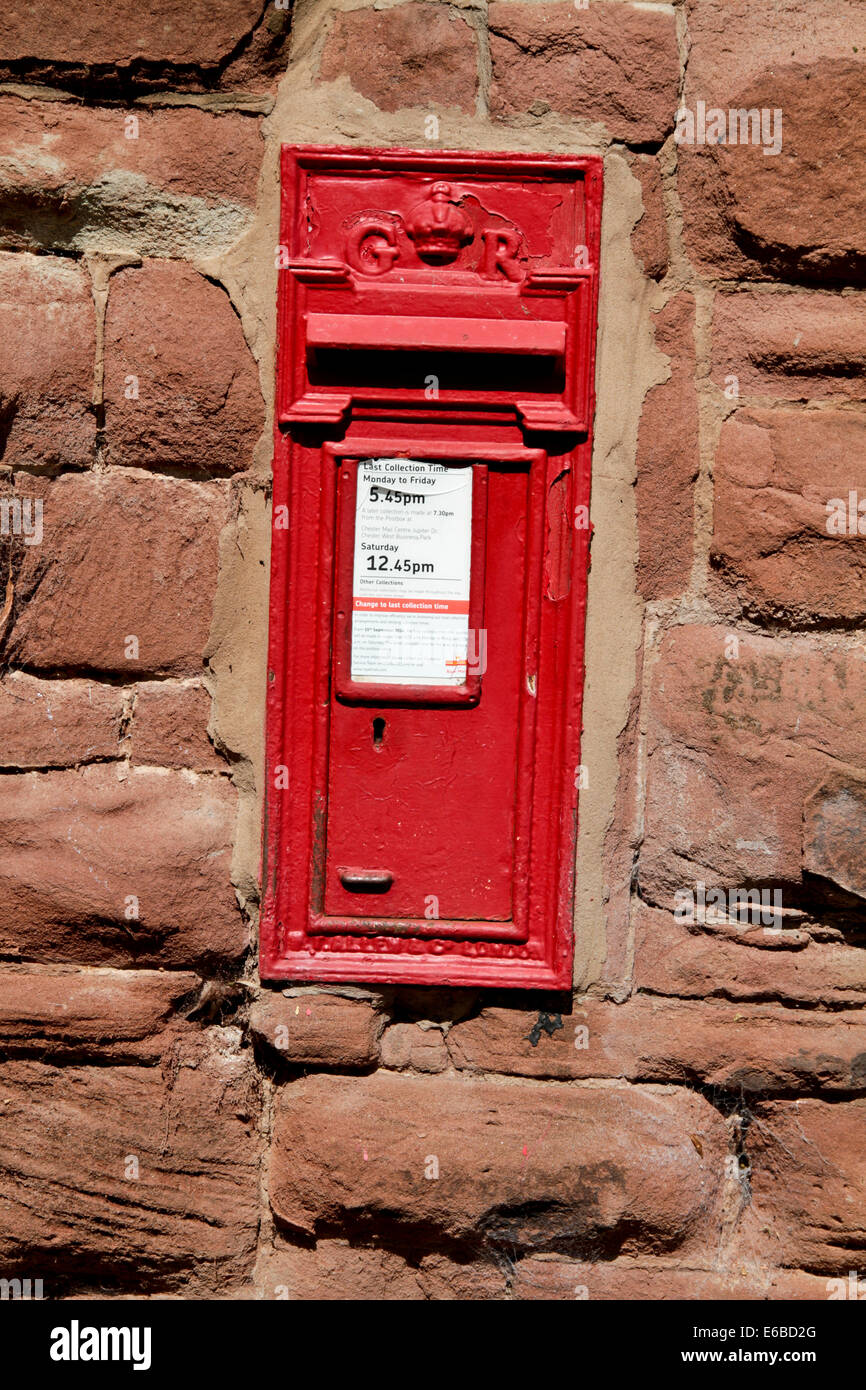 Red post box built into  a wall at Chester Stock Photo