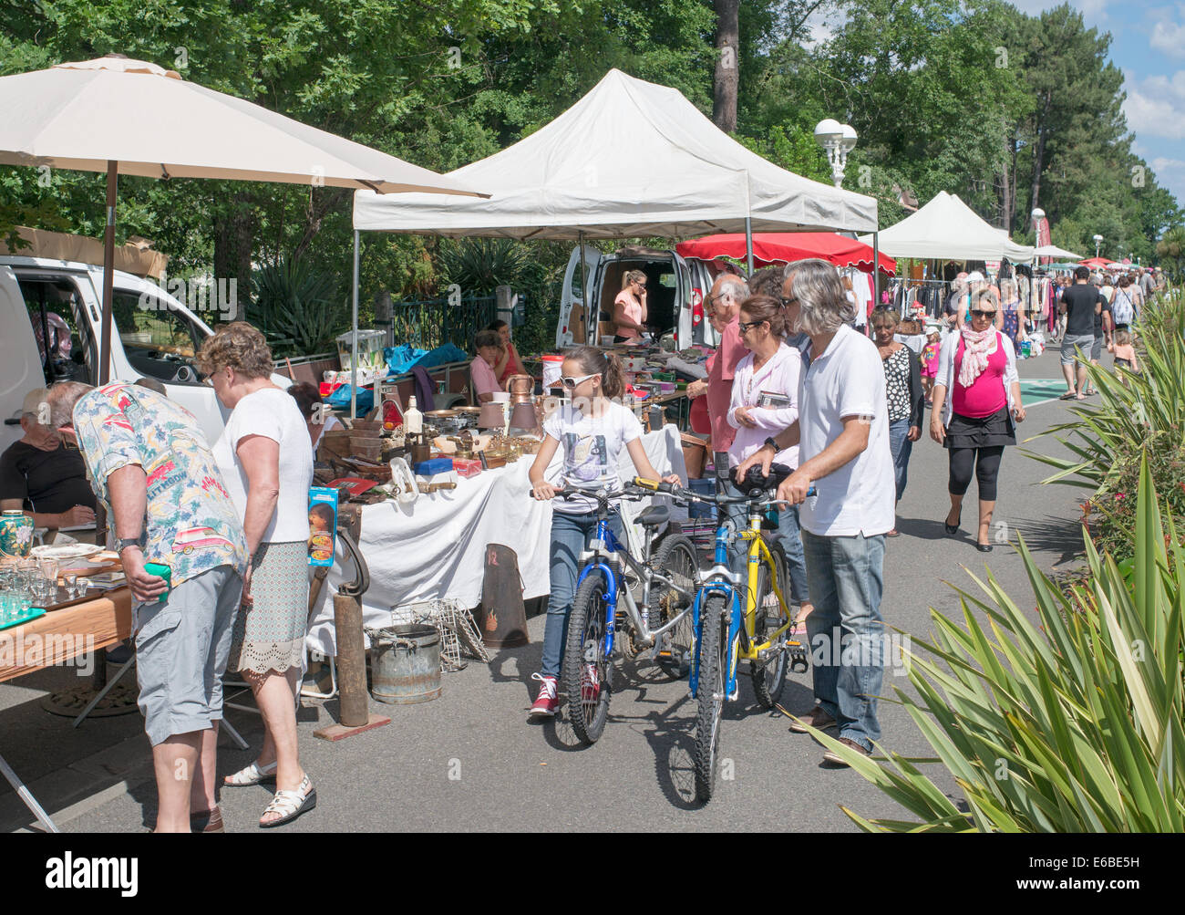 Family with bicycles car boot sale Sanguinet, Aquitaine, France, Europe Stock Photo