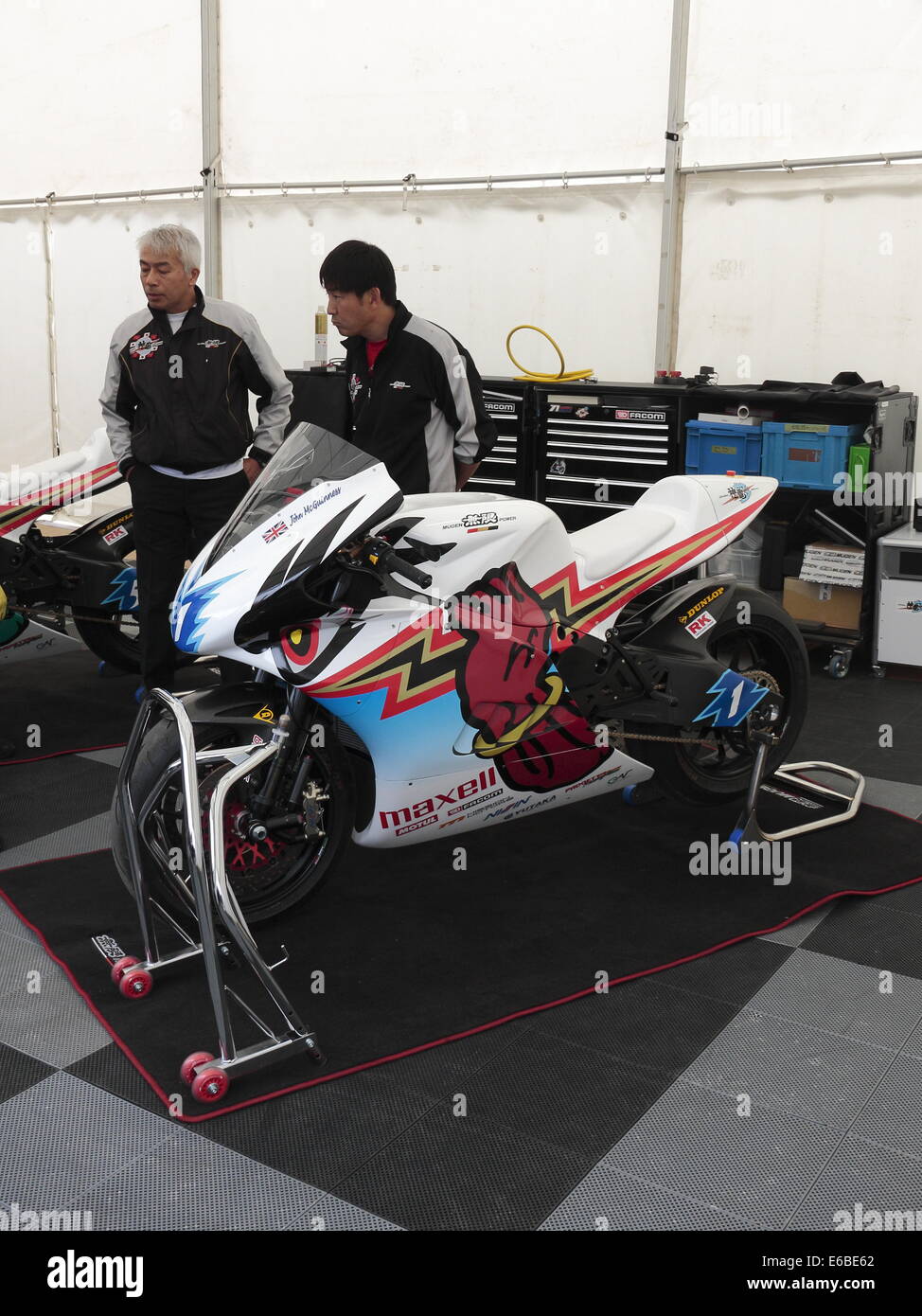 John McGuiness's Mugen electric motorcylce in the paddock for the Isle of Man TT 2014. Stock Photo
