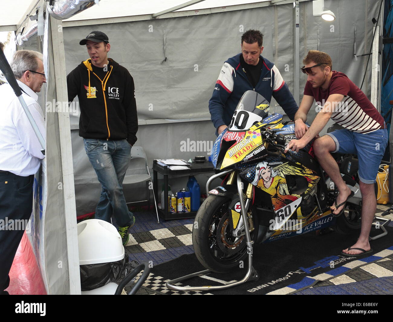 Peter Hickman (2nd left) and his BMW superbike  in the paddock, for the Isle of Man TT 2014. Stock Photo