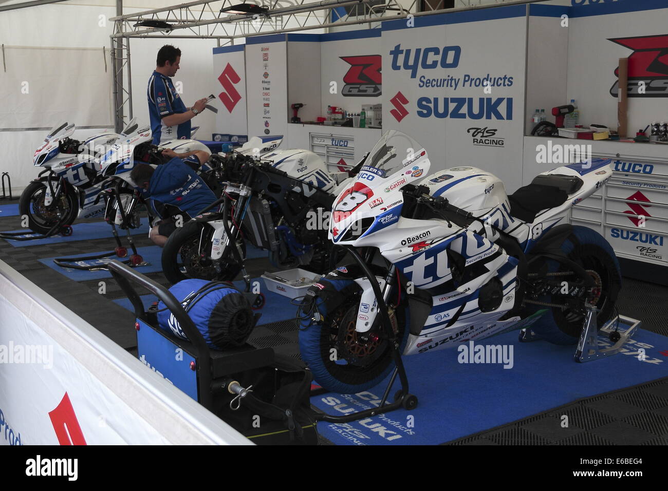 The Tyco Suzuki pit, with motorcycles for Guy Martin and William Dunlop, during the 2014 Isle of Man TT. Stock Photo