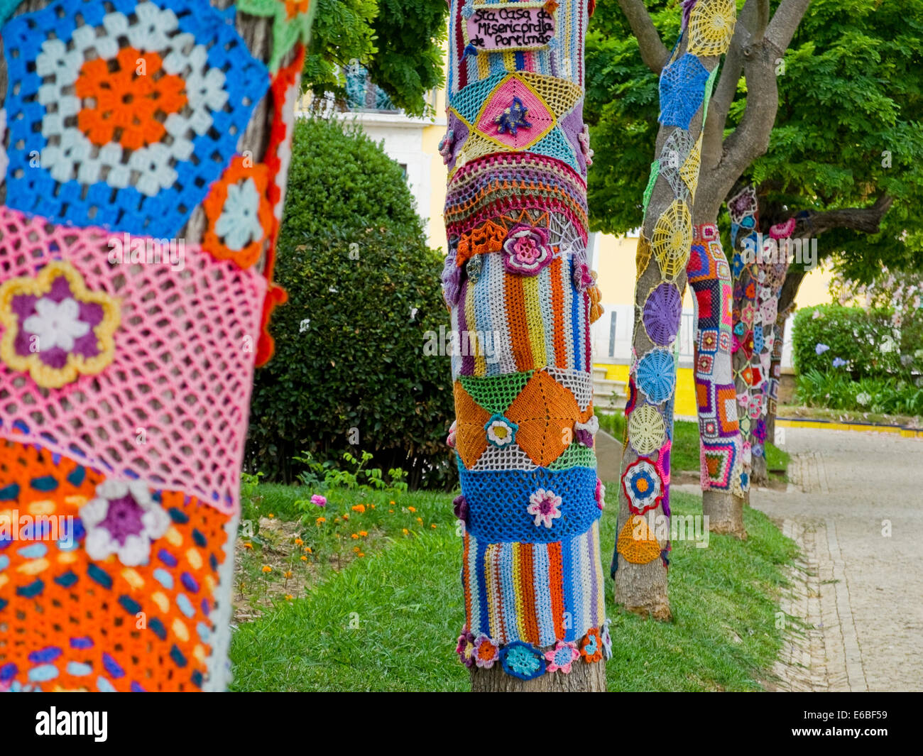 Yarn bombing in a trees. European park. Stock Photo