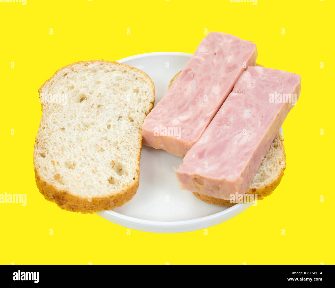 Two thick slices of processed ham on bread in plate atop a bright ...