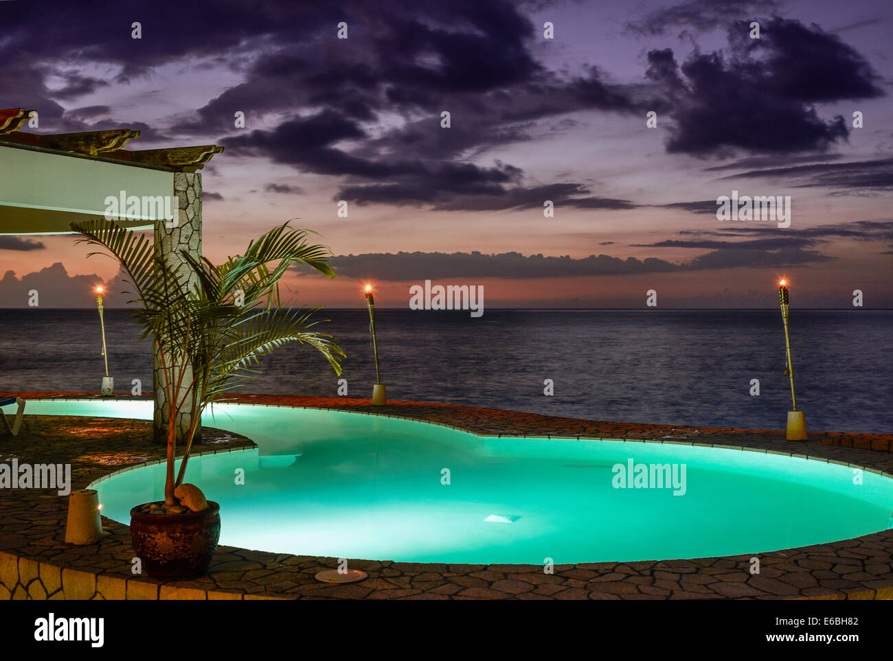 Resort oceanfront pool at dusk, Negril, Jamaica Stock Photo