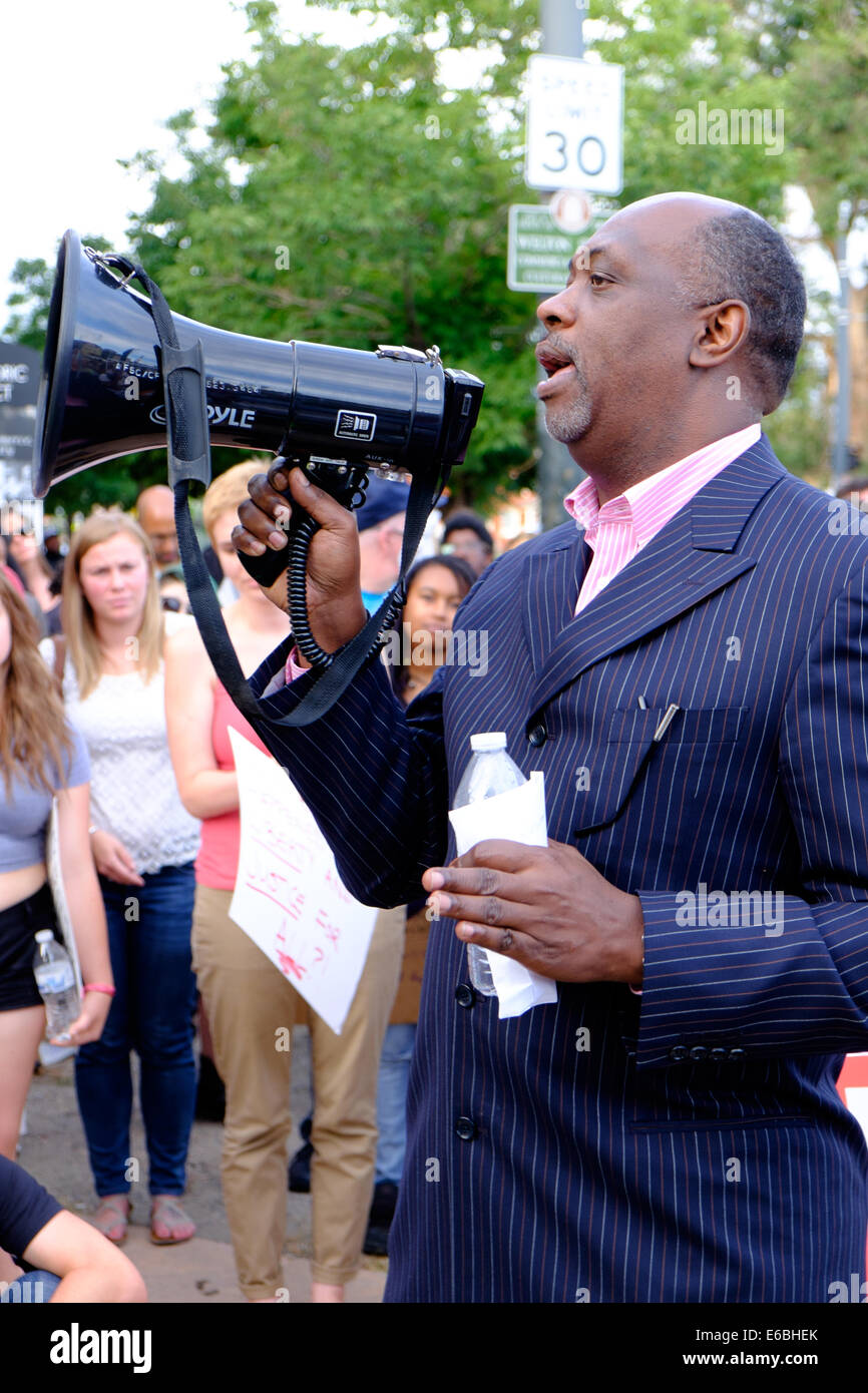 Denver, Colorado USA - 19 August 2014. Pastor Del Phillips from the House Worship Center blesses the crowd at Charles R. Cousins Plaza in Denver's Five Points Neighborhood.  Protesters marched from 24th and Welton Street to the State Capitol in support of 18-year-old Michael Brown who was fatally shot by a police officer on August 9th in Ferguson Missouri. (c) Ed Endicott/Alamy Live News Stock Photo