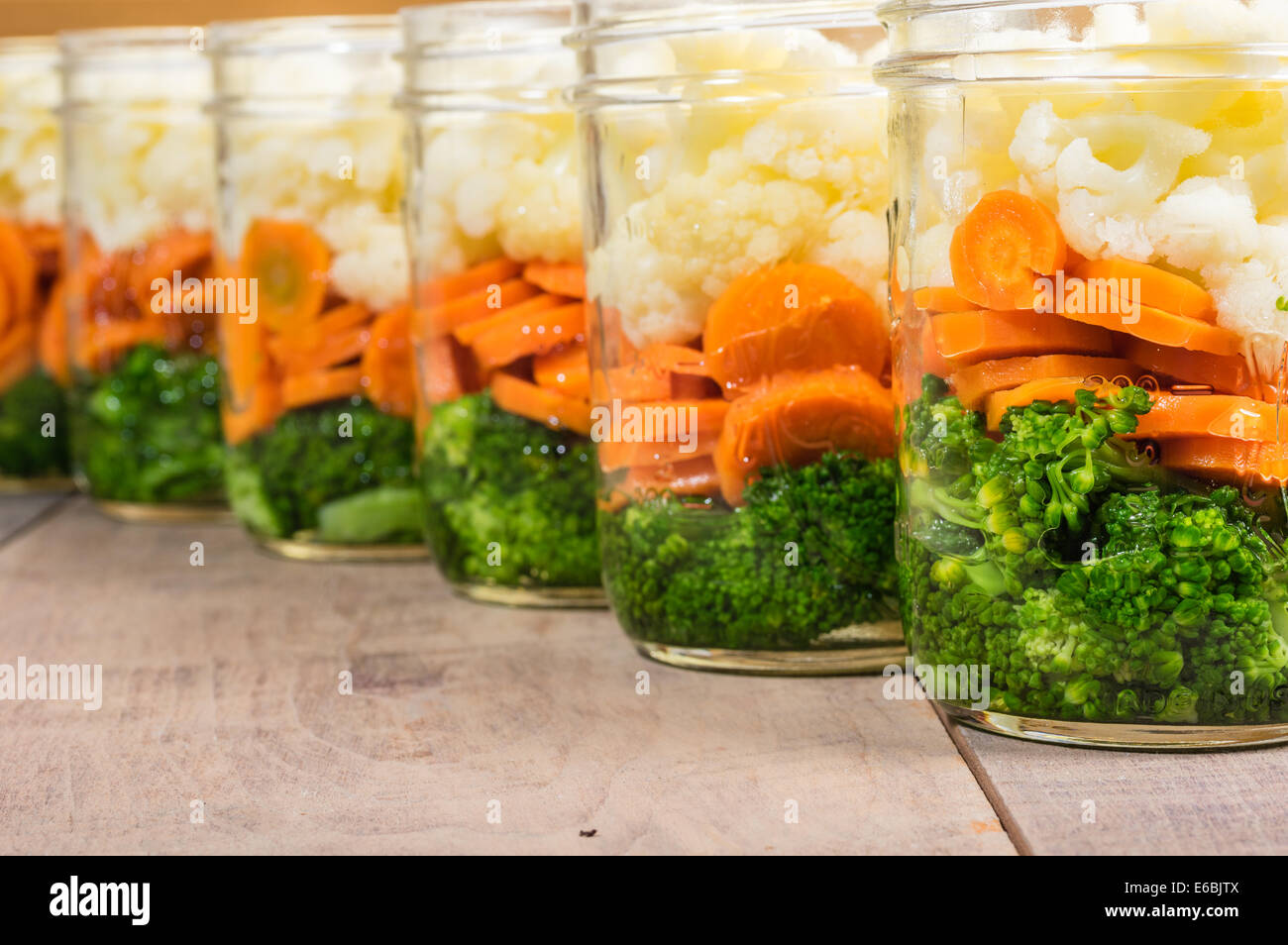 Jars of fresh cut vegetables ready to prepare for preserving Stock