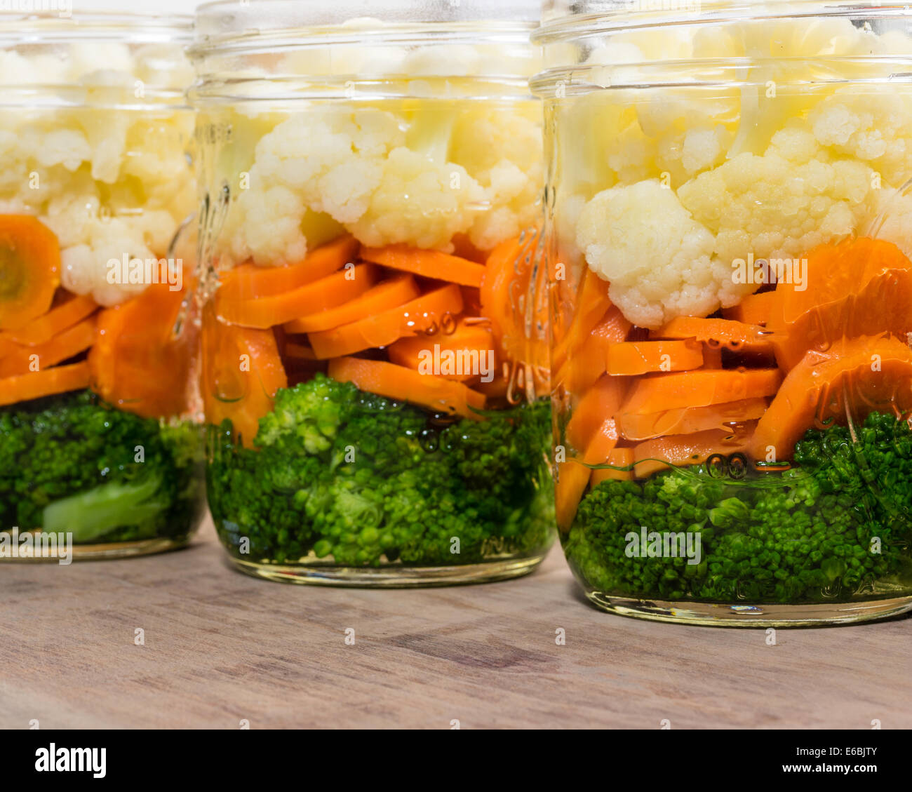 Jars of fresh cut vegetables ready to prepare for preserving Stock