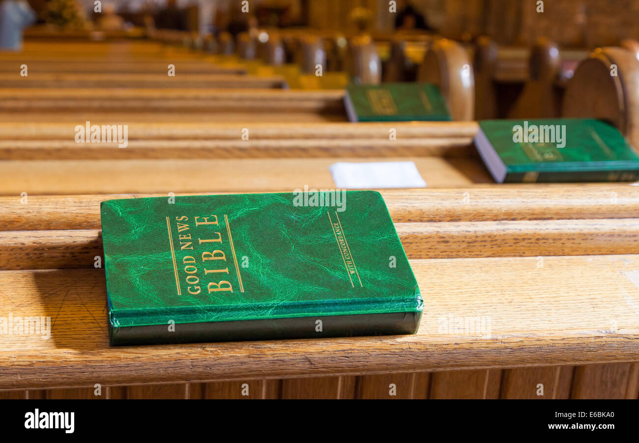 Good News Bible on a wooden church bench Stock Photo