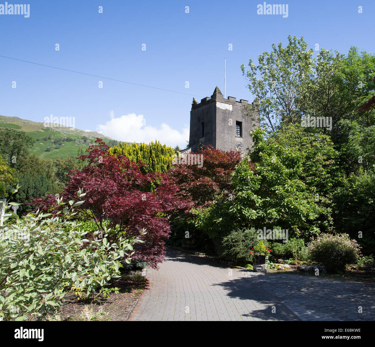 Grasmere church Lake District Cumbria England UK with blue sky on a beautiful summer day in the Lakes Stock Photo
