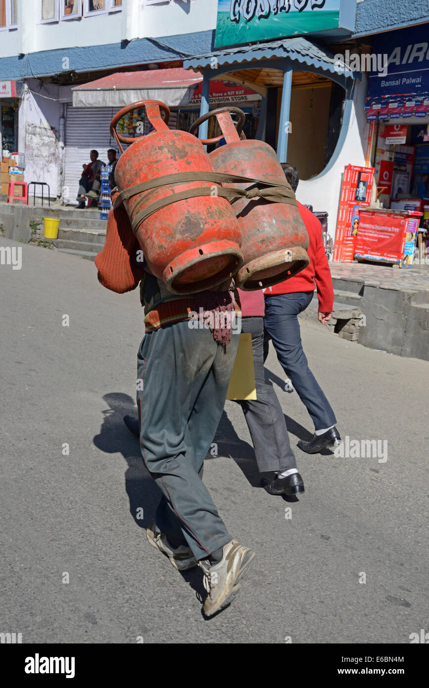 a-man-carrying-tow-filled-gas-cylinders-on-his-back-in-mall-road-shimla-E6BN4M.jpg