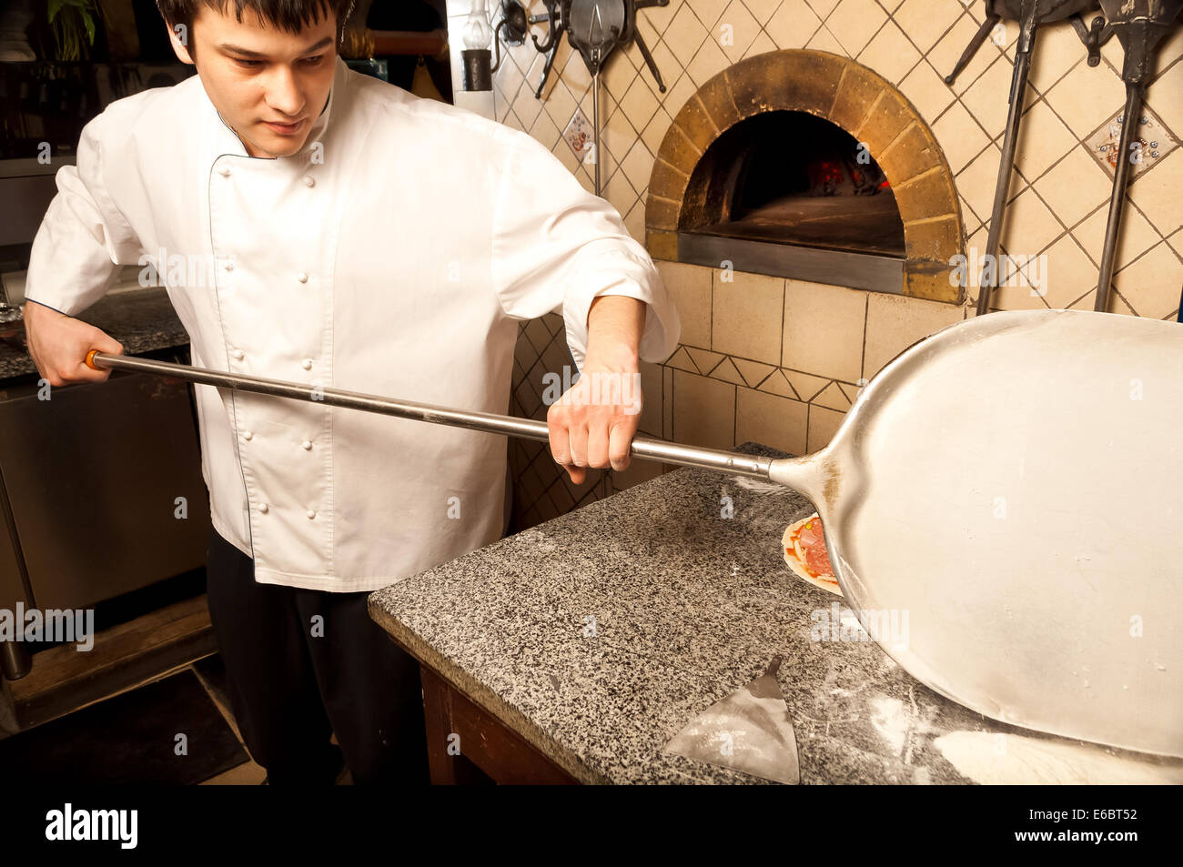 A process of preparing pizza by a chef Stock Photo