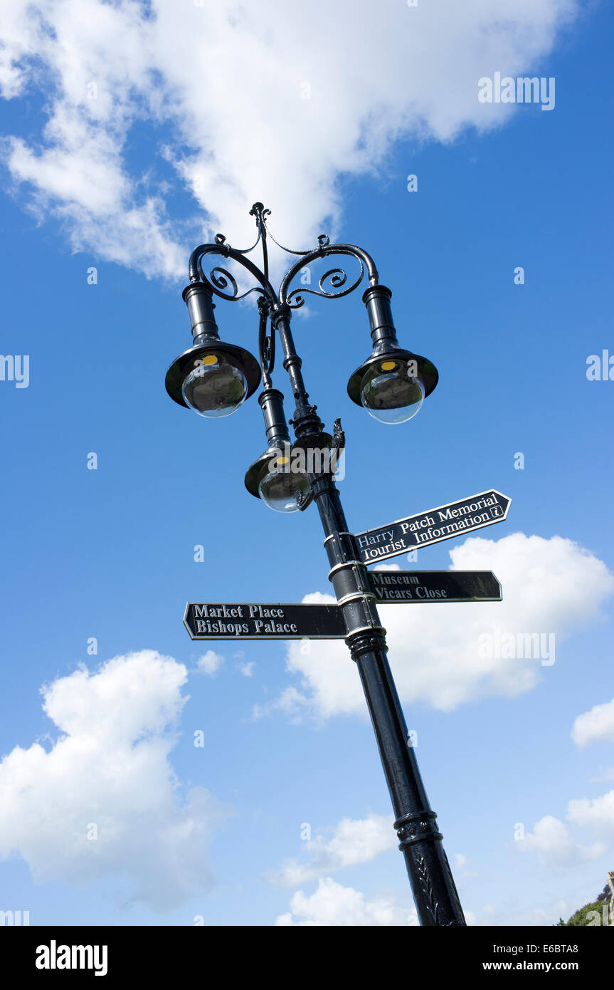 Ornate street lamp with direction signs in Wells Somerset UK Stock Photo