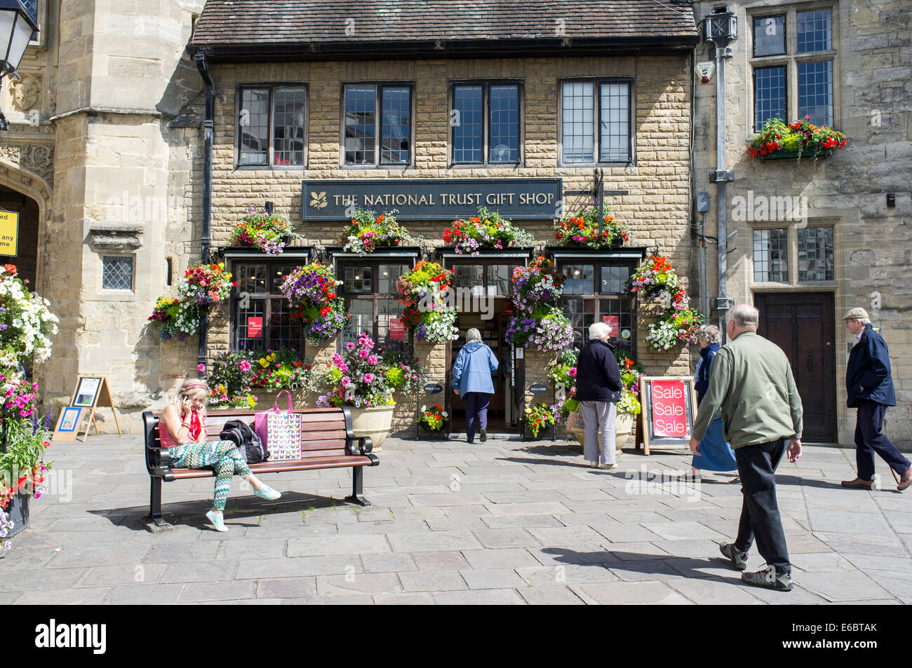 Hanging baskets of flowers outside National Trust gift shop in Wells Somerset UK Stock Photo Alamy