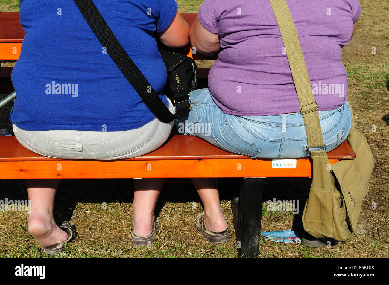 Two fat women sitting on a bench Stock Photo