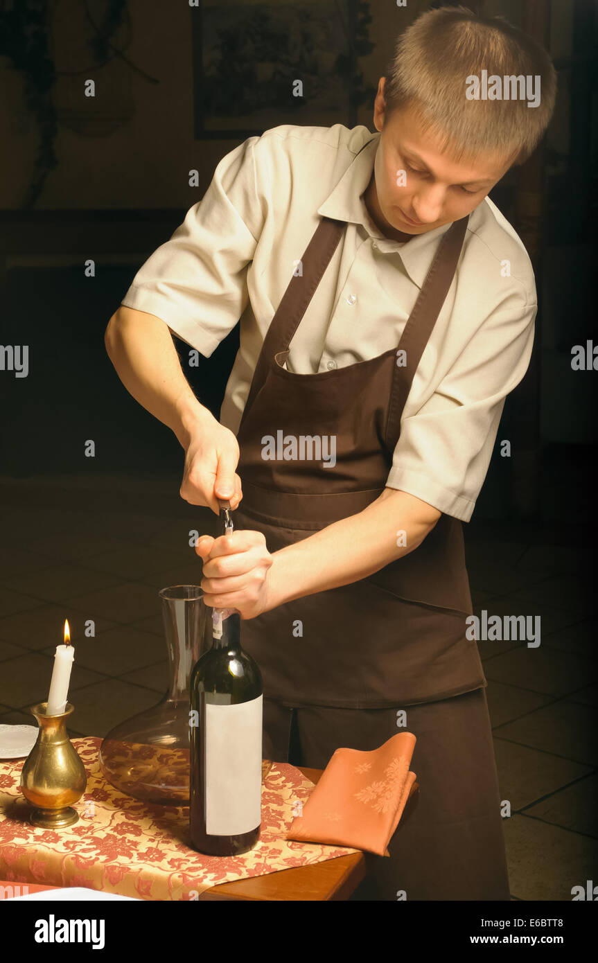 Sommelier opening wine bottle for blind winetasting Stock Photo