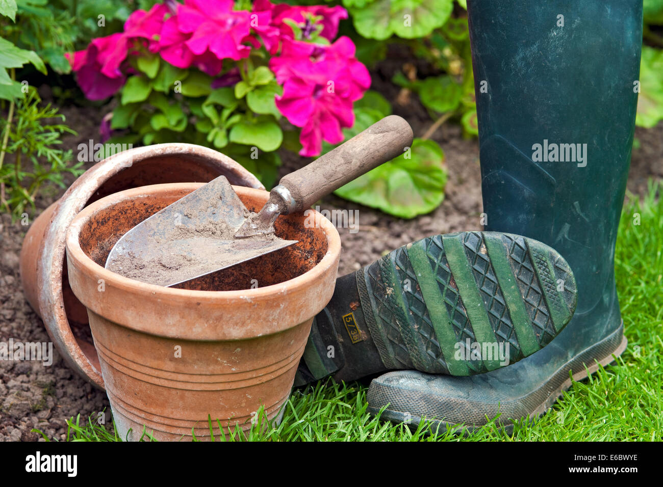 Close up of clay terracotta plant pots pot and a garden trowel England UK United Kingdom GB Great Britain Stock Photo