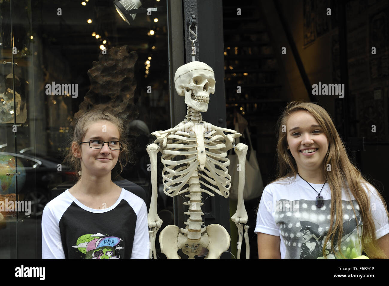 12 year old and 15 year old sisters posing with human skeleton. Manhattan, New York Stock Photo